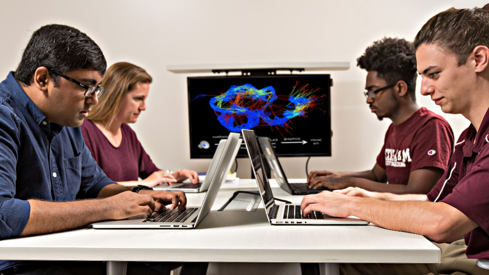 computer engineering students working in group classroom setting